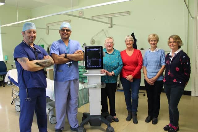 Alan Greef and Dr Narendrasinh Padhiyar with Barbara Boobyer, Betty Barker, Nancy Cartwright and Gillian Mann (nÃ©e Boobyer), and the new equipment.
