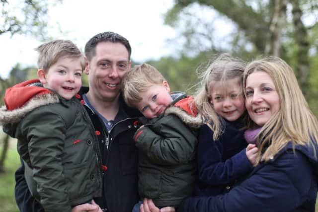 Cerri Belt with her husband and children EMN-181210-154528001