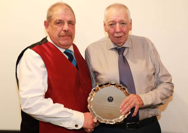 Caistor Cricket Club chairman Ben Jacob presents Wes Allison with a special award for 57 years service to the club. Picture: Gareth Johnson EMN-181015-104058002