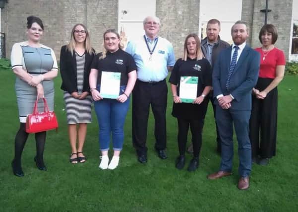 Millie and Grace, pictured with teachers from Louth Academy, parents and Rotarian President, Jim Randall.