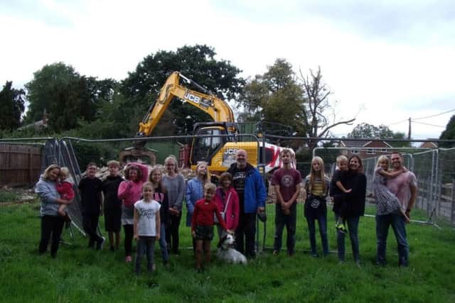 Residents of Carlton le Moorland turn out to see the demolition of the old village hall. Image supplied