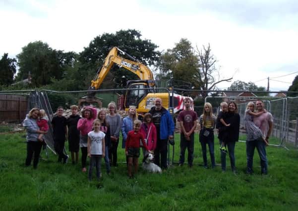 Residents of Carlton le Moorland turn out to see the demolition of the old village hall. Image supplied