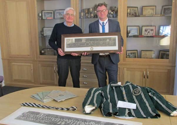 Mal Jones, left,from the Rase Heritage Society, and a former teacher at De Aston, presents the items to head teacher Simon Porter EMN-181016-154519001