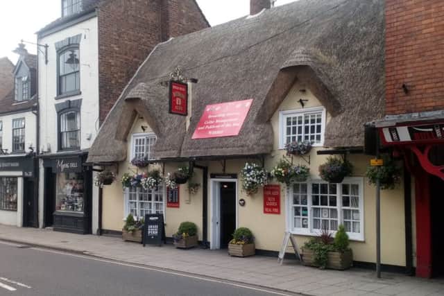 What a picture: The Kings Head in the towns Bull Ring, complete with thatched roof and impressive display of  hanging baskets.