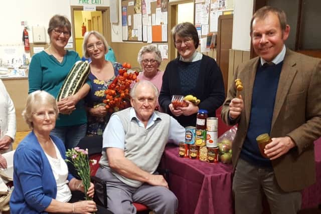 Auctioneer Nick Sharp (right) with helpers and successful bidders, from left, Joy Oxborrow, Joan Saundby, Rosie Brumpton, Elizabeth Campbell, Jill Sellers, Rev Anne Coates (and seated) Viv and Mick Harper EMN-181019-063913001