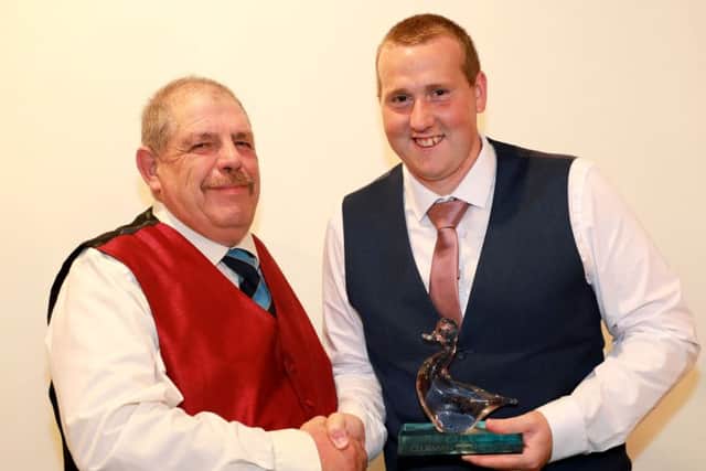 Caistor CC chairman Ben Jacob presents James Parker with Clubman of the Year 2018 EMN-181019-100424002