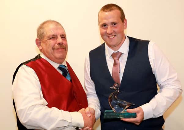Caistor CC chairman Ben Jacob presents James Parker with Clubman of the Year 2018 EMN-181019-100424002