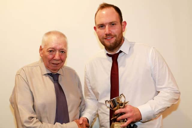 Wes Allison presents Danny Bevis with the First XI Batting Trophy EMN-181019-100337002