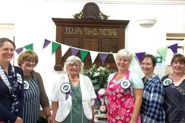 Harmston WI members in front of the First World War memorial plaque during their Autumn Fair. EMN-181030-151706001