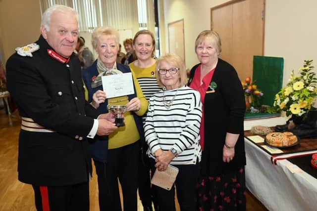 Lincs South WI Make, Bake and Show event. Lord Lieutenant of Lincolnshire Toby Denis presenting Navenby WI members with the Co-operative cup, joint winners with Sibsey, L-R Gina Newstead, Tina Orange, Liz Ray and Federation Chairman Debbie Venn. EMN-181029-091816001