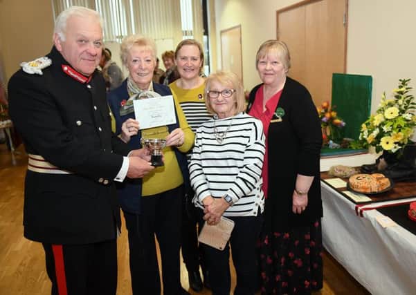 Lincs South WI Make, Bake and Show event. Lord Lieutenant of Lincolnshire Toby Denis presenting Navenby WI members with the Co-operative cup, joint winners with Sibsey, L-R Gina Newstead, Tina Orange, Liz Ray and Federation Chairman Debbie Venn. EMN-181029-091816001