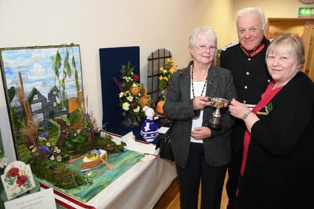 Lincs South WI Make, Bake and Show event. L-R Sally Grant of Sibsey WI receiving the Co-operative Cup (joint winnner with Navenby), Lord Lieutenant Toby Denis, federation Chairman Debbie Venn. EMN-181029-091829001