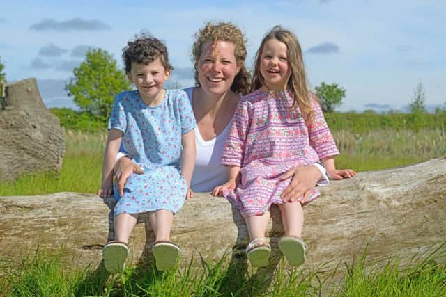 Judith Jenkinson, (pictured centre), celebrating her win with her two children, Alice, (left) and Alexandra, (right).