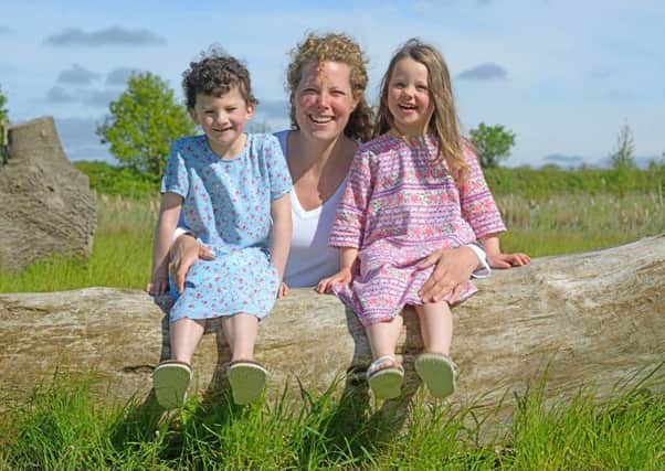 Judith Jenkinson, (pictured centre), celebrating her win with her two children, Alice, (left) and Alexandra, (right).