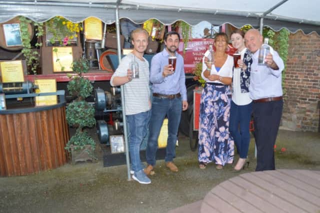 PinGins Alan Bottomley and Amy Conyard , pictured with the team from Batemans Brewery.