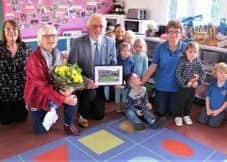 Mr and Mrs Maxwell with commitee members and pupils