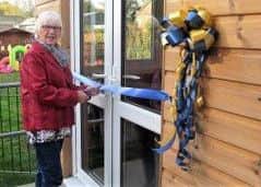 Angela Maxwell cuts the riboon at the official opening