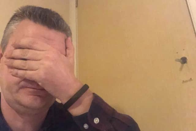Face palm - Scott Dalton with the fire door in the background.