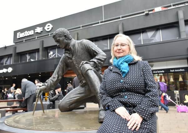 Helan Wass, HS2 lead archaeologist, with the statue of Captain Matthew Flinders at Euston Station, London.