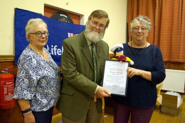 Brenda Hartill - and one of her knitted crew - collected her certificate from Graham Smith EMN-181029-072524001