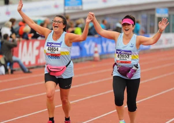 Helen and Louise cross the line together in Amsterdam's Olympic Stadium EMN-181029-102436002