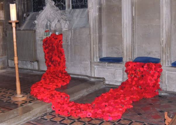 Poppies pour out of recesses around the altar of Heckington Church in the Sea of Poppies display. EMN-181030-100716001