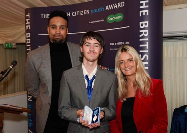 Winner of the British Citizen Youth Award, Jordan Havell, pictured with Diversitys Ashley Banjo, (left), and Nicky Cox - editor of First News, (right).