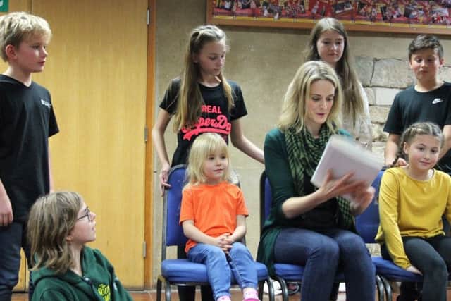 The hills are alive, with the sound of music... Helen Graves, who plays Maria Von Trapp, rehearsing with one of the sets of children. EMN-180511-114934001
