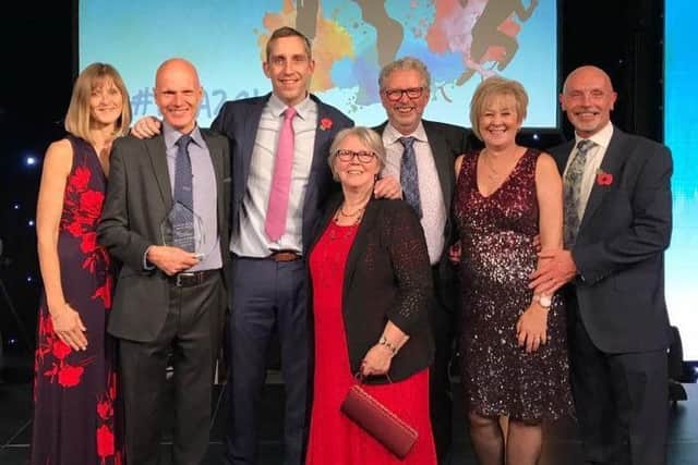 The Striders pick up their award from Olympic medal-winner Steve Parry EMN-180211-130420002