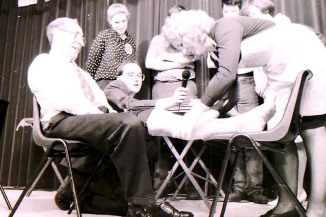 Generation Game antics for charity at Heckington. Dr Frank Pinchbeck receives some rough treatment in the bandaging challenge. EMN-180211-122548001