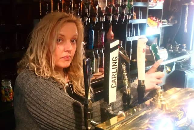 Landlady Penny Wells behind the bar at the new-look Ship Inn .