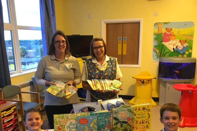 Books are handed over to the children's unit at Boston's Pilgrim Hospital
