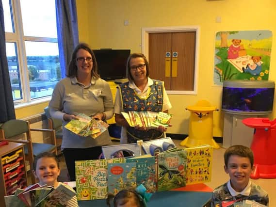 Books are handed over to the children's unit at Boston's Pilgrim Hospital