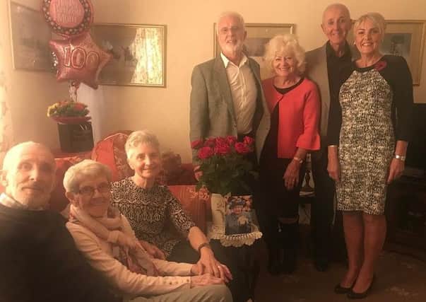 Lily Nayor surrounded by her family on her 100th birthday. ANL-180211-170344001