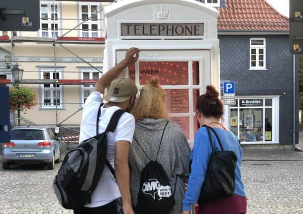 Young people reading the names of the fallen in Skegness and bad Gandersheim. ANL-180211-111442001