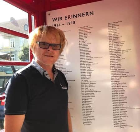 Artist John Byford inside the telepohone box where the names of the fallen are displayed. ANL-180211-111526001