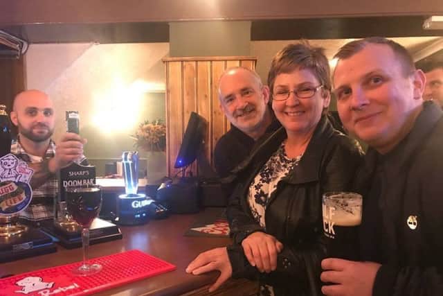 First customers at the bar at the White Hart hotel in Spilsby with  obe of the new lease holders Tony DAmbrosio. ANL-180311-133101001