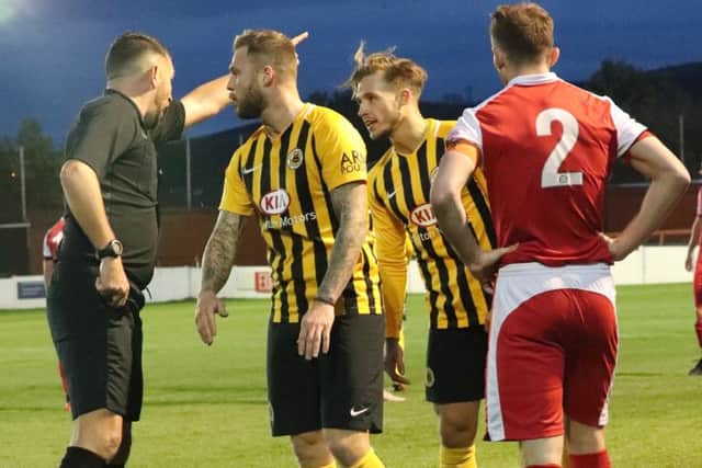 Brad Abbott, right, is dismissed by referee David McNamara. Photo: Eric Brown.