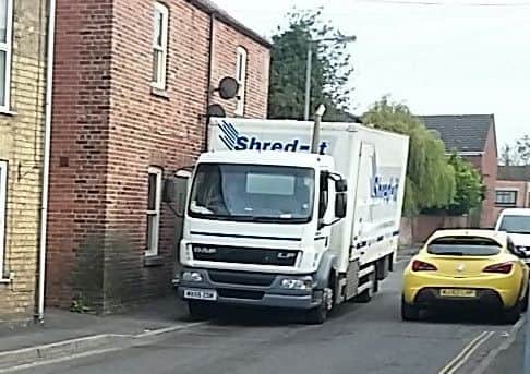 Large vehicles are passing front doors with inches to spare