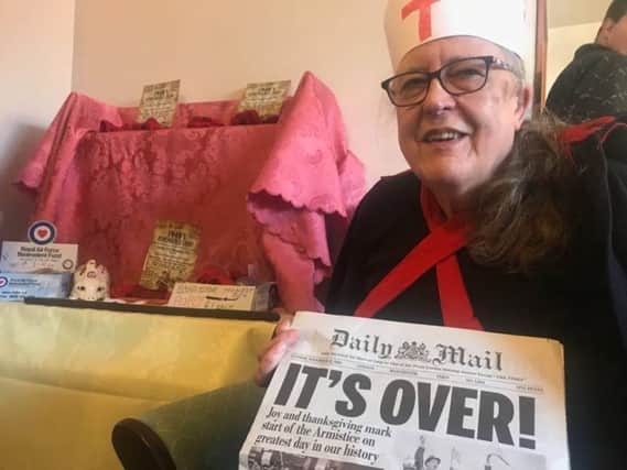 Pamela Harper celebrating the wartime headline 'It's over'. at the 1940s event at the Philip Grove Community Centre. ANL-181211-100340001