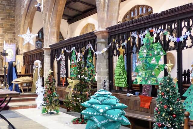 Christmas trees in the chancel at last year's event EMN-181211-210159001