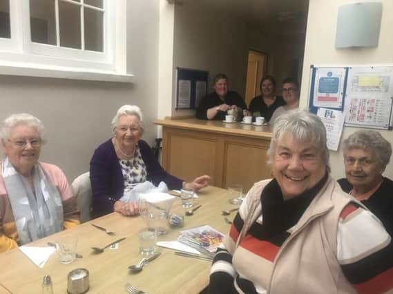 Spilsby's senior residents are being invited to a free community Christmas lunch. Volunteers from Spilsby Christian Fellowship  (pictured making a cuppa) popped into the weekly luncheon club at the Franklin Hall to spread the word. ANL-180611-091532001
