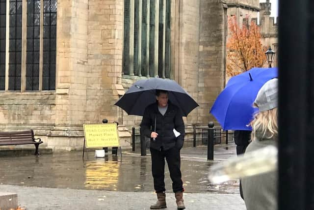 US actor Rob Lowe taking cover under an umbrella in Boston Market Place. Photo by BBC Lincolnshire reporter Harry Parkhill.