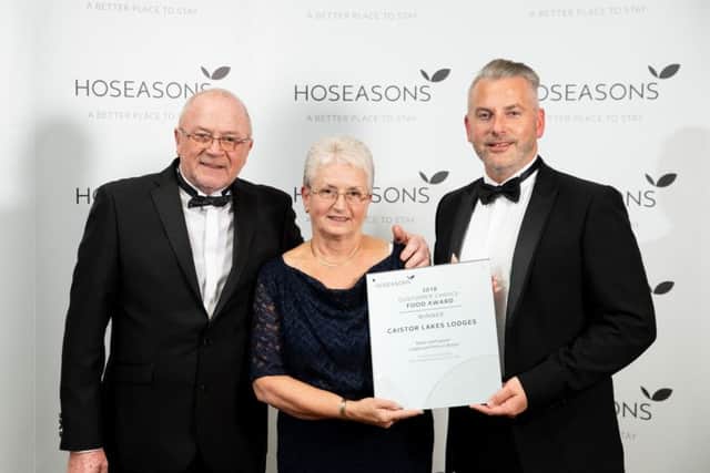 Members of the Caistor Lakes Lodges team, Les Pert and Joyce Pert, receive their award from Hoseasons Head of Product, Scott Drew ( right). Picture:
Darren Cool - 07792308722 - www.dcoolimages.com EMN-180911-080157001