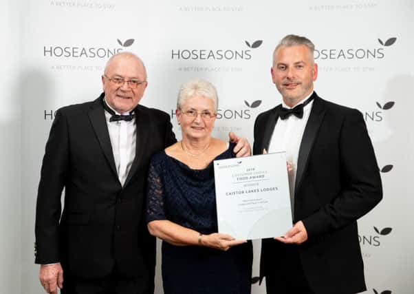 Members of the Caistor Lakes Lodges team, Les Pert and Joyce Pert, receive their award from Hoseasons Head of Product, Scott Drew ( right). Picture: Darren Cool - 07792308722 - www.dcoolimages.com EMN-180911-080157001