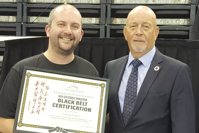Dan Pearce with grandmaster ninth-degree black belt David Oliver EMN-180711-135011002