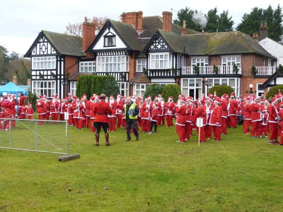 Some of the Santas who took part in the 2017 dash gather  at the starting  line.