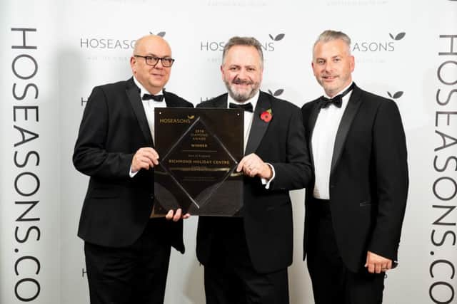 Members of the Richmond Holiday Centre team, Steve Parish and Andrew Downing, receive their award from Hoseasons Head of Product, Scott Drew (far right). Photo: Darren Cool ANL-180911-081338001