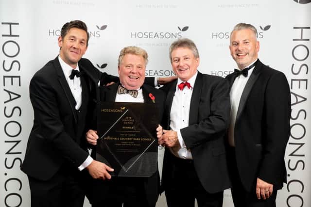 Members of the Woodhall Country Park Lodges team, Leigh Hall, James Reid and Steven Schofield, receive their award from Head of Product, Scott Drew (far right). EMN-180911-160533001