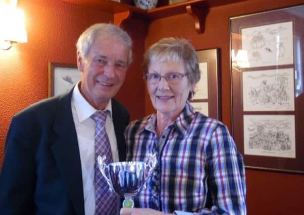Hazel Clift is seen receiving her prize for the clubs Most Improved Player from secretary Tom Johnson.